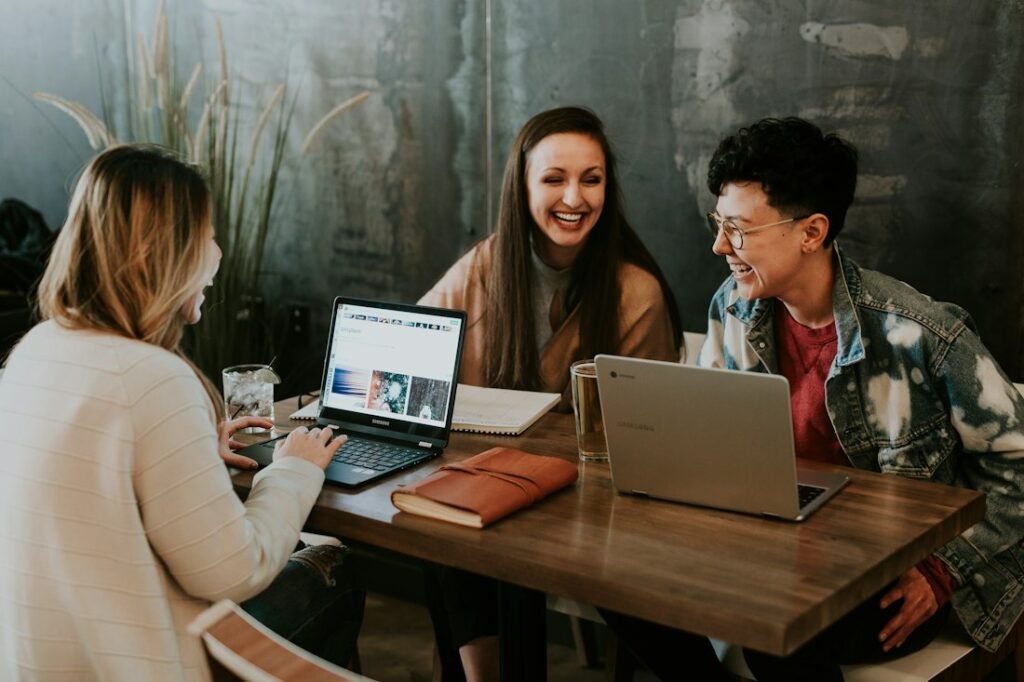 A marketing team planning a campaign around a table with laptops